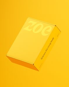 a yellow box sitting on top of a yellow table next to a white object with the number 200 written on it