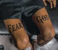 two people with tattoos on their legs that say, fear