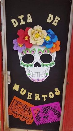 a door decorated with flowers and a skeleton wearing a flower headdress for dia de muertos