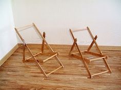 two wooden chairs sitting on top of a hard wood floor