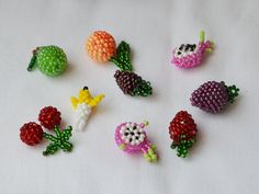 small beaded fruits and vegetables on a white surface