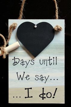 a sign that says days until we say i do with a black heart on it