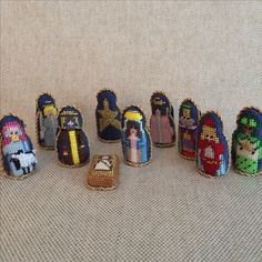 a group of needled nativity figurines sitting next to each other