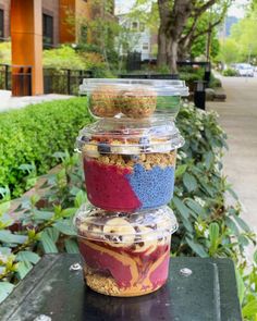 there are three containers stacked on top of each other with food in them and one container is filled with cereal