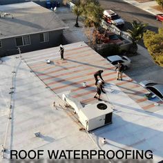 two men are working on the roof of a house