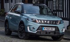 a blue suv parked on the side of a road