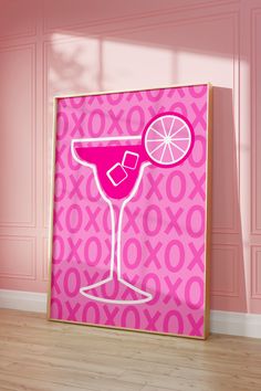 a pink poster with a cocktail glass and an orange slice on the rim in front of it