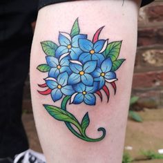 a blue flower with green leaves on the thigh