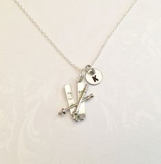 "Beautiful Simplistic Skiing Necklace with your choice of Initial. This is a wonderful unique and awesome for anyone that ski's! This can also be a wonderful necklace for anyone who appreciates unique and different necklaces, and loves skiing! Elegant and simplistic yet creative and makes a wonderful statement. Includes: ●Skiing Pendant- Measurements: 23mm x 18mm (appr. 0.9 inch x 0.7 inch) ●Pendant is Antique Silver Plated and made from a zinc alloy metal which is lead and nickel free. ●Initial Snow Jewelry, Ski Bar, Antique Skis, Hamsa Necklace Gold, Real Diamond Necklace, Good Luck Necklace, Dainty Diamond Necklace, Double Black, Diamond Evil Eye