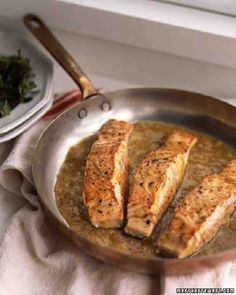 some fish is cooking in a pan on the stove