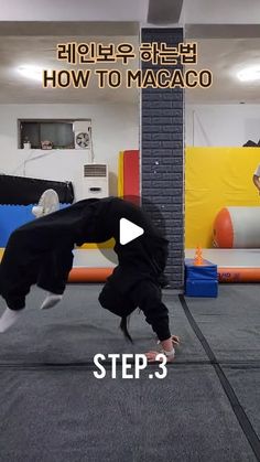 a man doing a handstand on the floor in front of an obstacle course