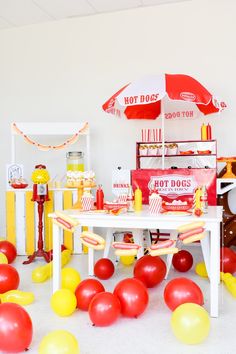 a table with red and yellow balloons on it