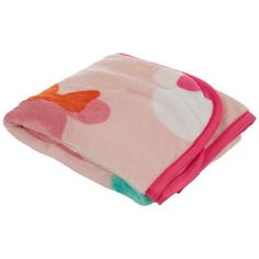 a pink blanket with an orange and white flower design on it, folded up against a white background