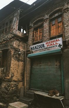 an old building with a sign that says manzor medical