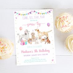 a birthday party with cupcakes, cake and dog themed items on the table