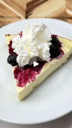 a slice of cheesecake with berries and whipped cream