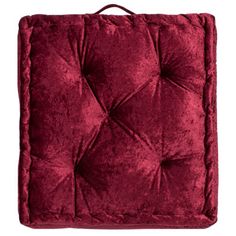 a red velvet square cushion on a white background with clipping for text or image