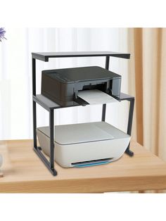 a computer desk with a printer on it