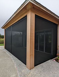 a small building with a black covering on it