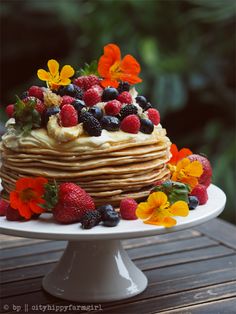 a cake with fruit and flowers on top