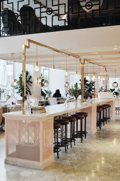 an empty restaurant with lots of tables and stools