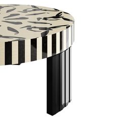 an artistically designed table with black and white stripes on the top, in front of a white background