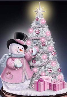 a snowman next to a christmas tree