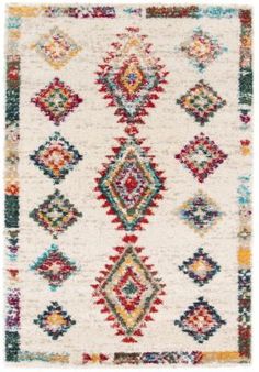 a white rug with multicolored diamonds on the front and back of it,