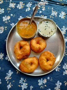 doughnuts and dipping sauce on a silver plate