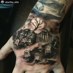 a hand with a graveyard scene on it