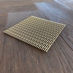 a wooden floor with a metal grid design on the top and bottom part of it