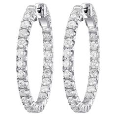 These elegant hoop earrings are crafted in 18K white gold, providing a modern and luxurious appeal. Adorned with a total of 2.60 carats of brilliant-cut diamonds, these earrings offer a radiant sparkle that enhances any look. The diamonds are meticulously set on both the inner and outer surfaces of the hoops, ensuring they catch the light from every angle. With their timeless design, these hoop earrings are versatile enough to complement both casual and formal attire. Whether you're looking for Earring Video, Modern Hoop Earrings, Diamond Earrings For Women, Gold Diamond Hoop Earrings, Radiant Diamond, Diamond Hoop Earrings, Stunning Earrings, Formal Attire, Modern Earrings