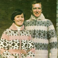 two people standing next to each other wearing sweaters