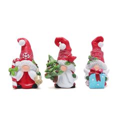 three christmas gnome figurines with presents