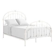 a white metal bed frame with two pillows