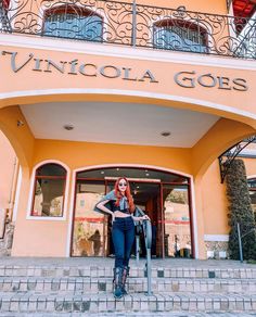 a woman standing on steps in front of a building