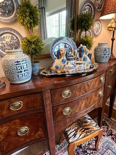 a dresser with blue and white china on it