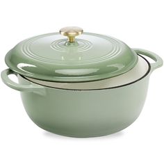 a green casserole with a gold lid