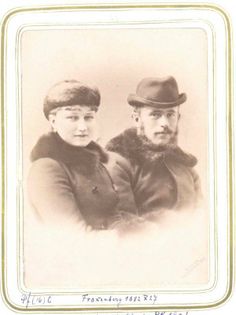 an old black and white photo of two men in hats, one with a beard