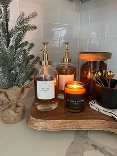 some candles are sitting on a tray next to a potted plant and other items