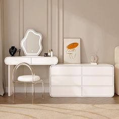 a white dresser sitting next to a chair in a living room