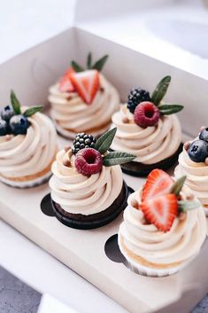 an instagram photo of some cupcakes with berries and cream frosting on them