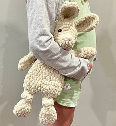 a woman holding a stuffed animal in her arms