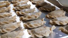 some dumplings are sitting on a metal tray