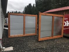 two wooden gates with metal slats on them