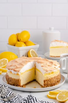 there is a lemon cheesecake on the table with two slices cut out and ready to be eaten