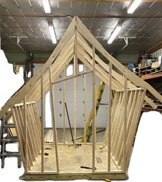 the inside of a building being built with wooden framing and roof trusss on it