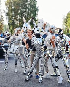 a group of people that are standing in the street with some silver foil on them