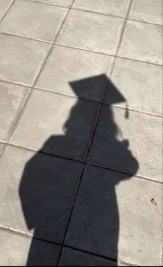 a shadow of a person holding an umbrella