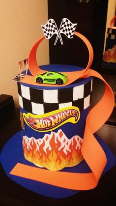 a birthday cake made to look like a race car on top of a blue hat